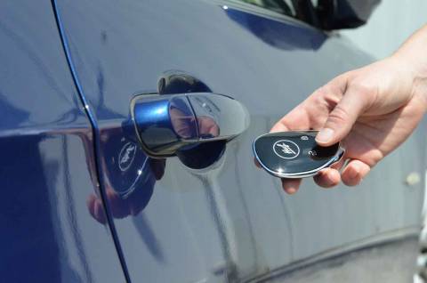 Huf Smart Key in front of car door handle to open car via NFC technology